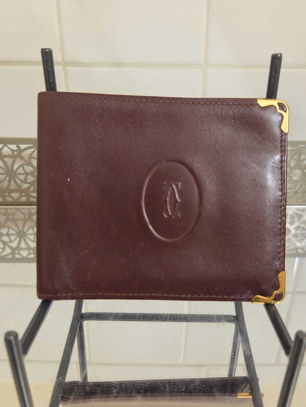 Cartier Leather Bifold Wallet in Deep Maroon with Gold Corner Accents